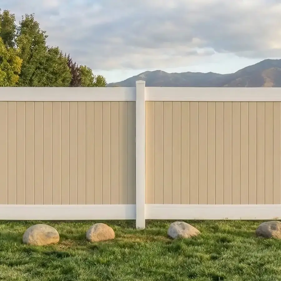Low Maintenance Beige And White Vinyl Fence Providing Privacy For A Large Grassy Yard Under A Cloudy Sky 2
