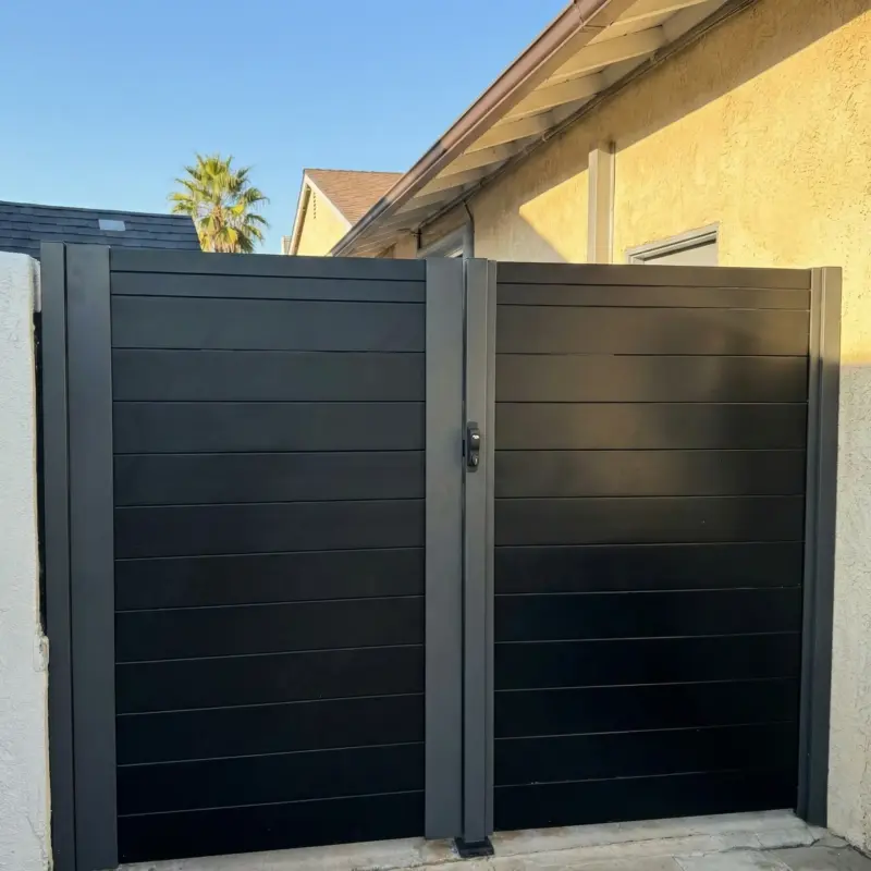 Matte Black Aluminum Privacy Gate With A Contemporary Horizontal Plank Design Installed At A Residence