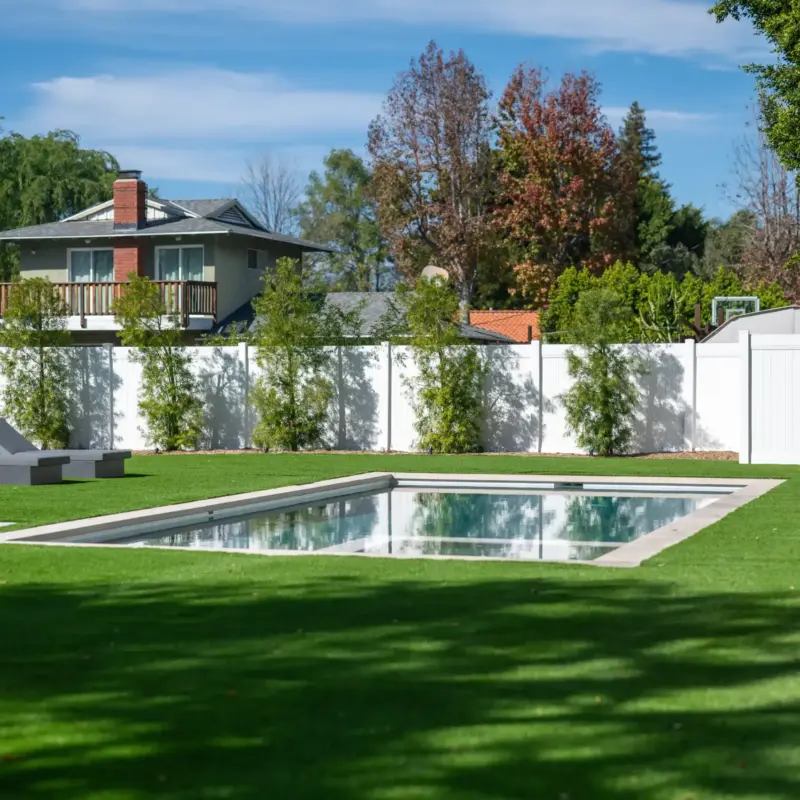 Backyard Pool And White Privacy Fence